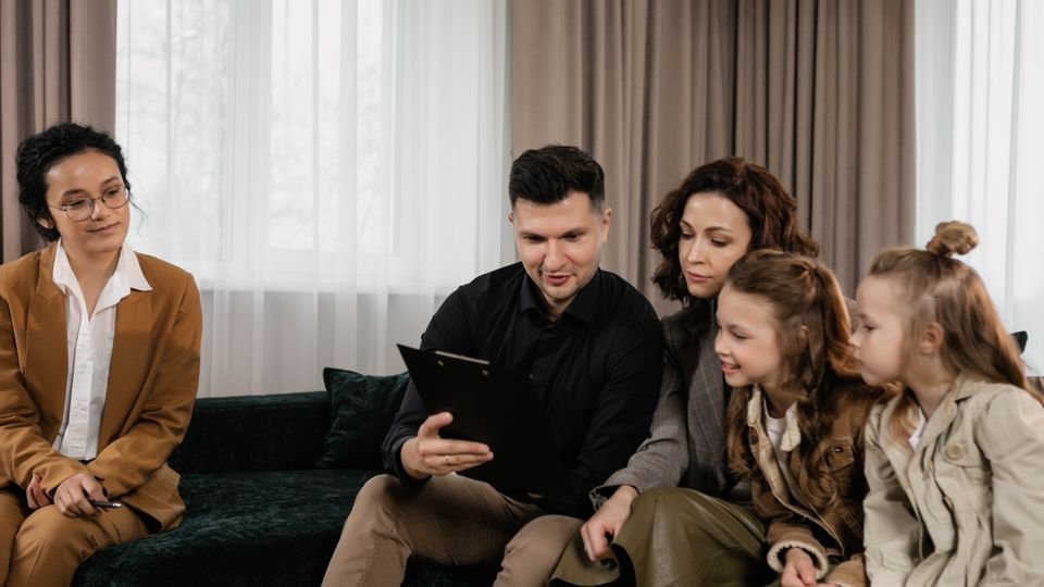 Família analisando um documento durante uma conversa de orientação.